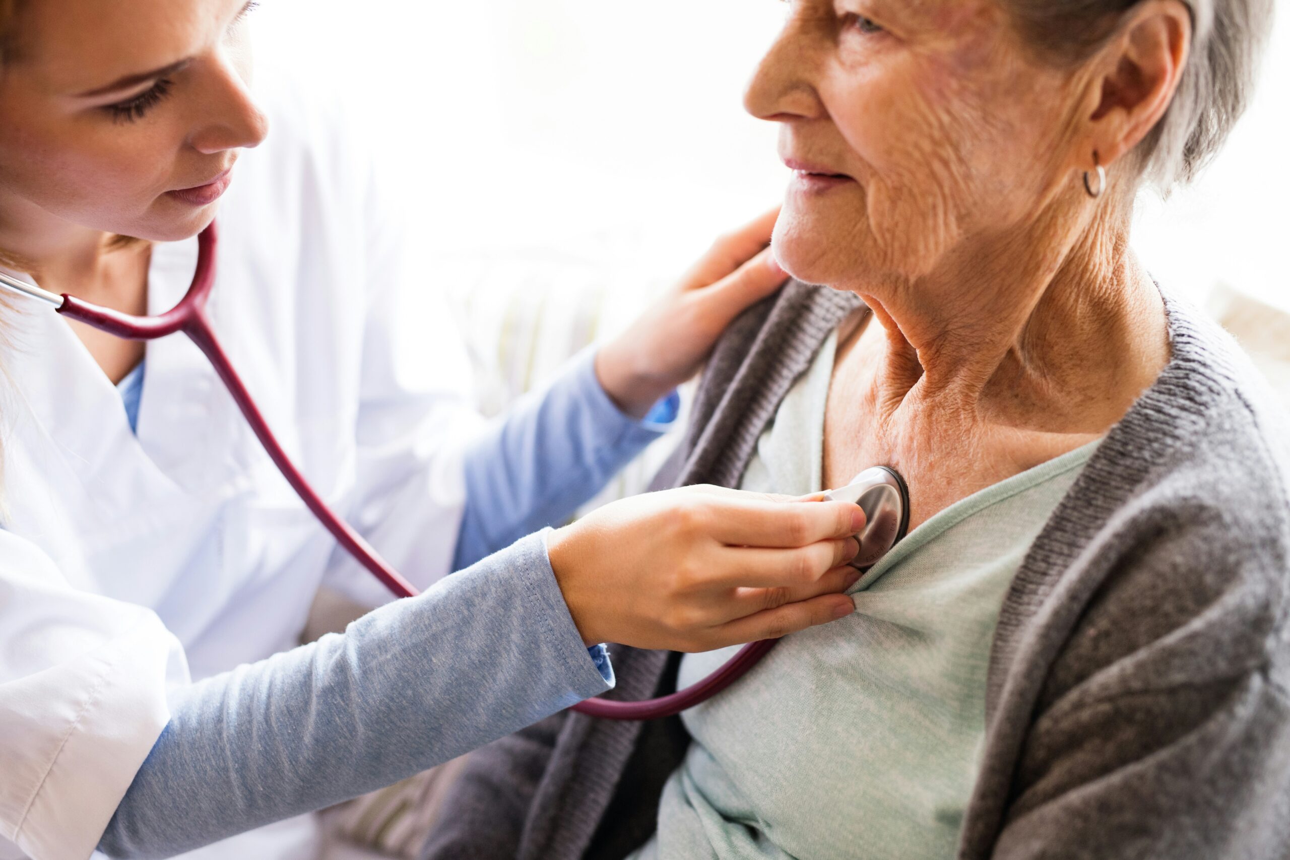 An older female client receiving healthcare consultation, representing Medicare plan reviews and retirement preparation.